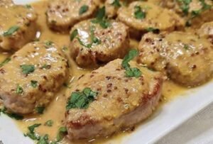 Medallones de cerdo (lomo) en salsa de vino, filete de salmón en salsa de mostaza